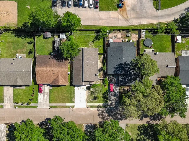 an aerial view of a house with a garden and lake view