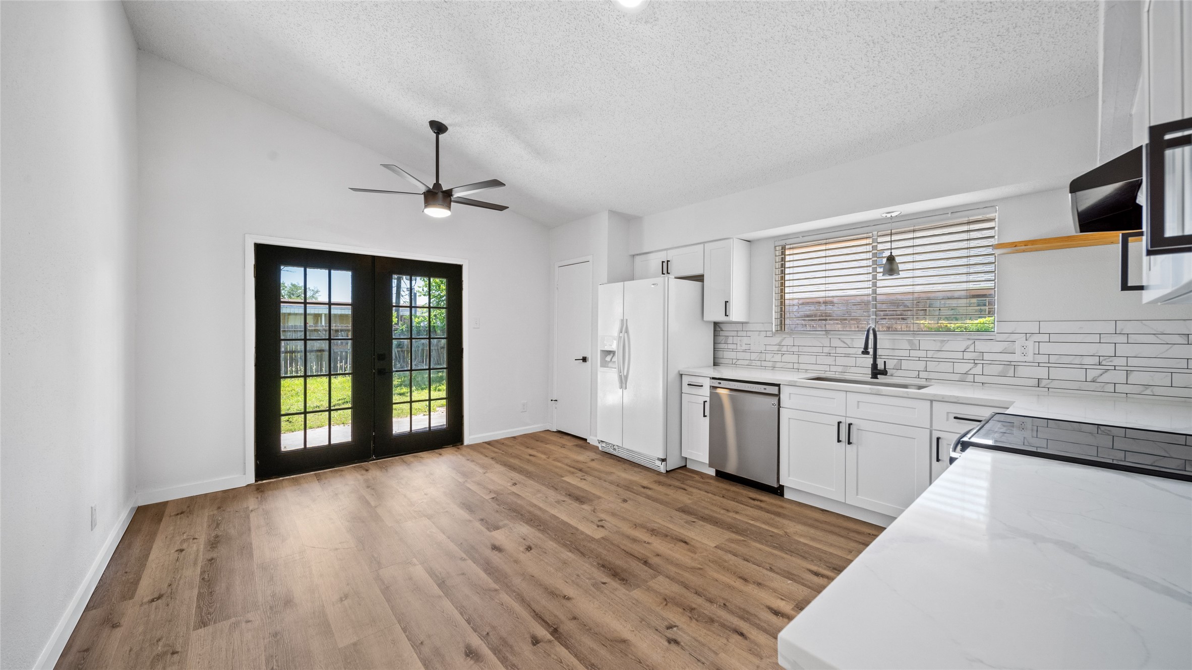 23414 Canyon Lake Drive Spring, TX 77373 - Photo 2 of 21 a kitchen with granite countertop a stove a sink and a refrigerator