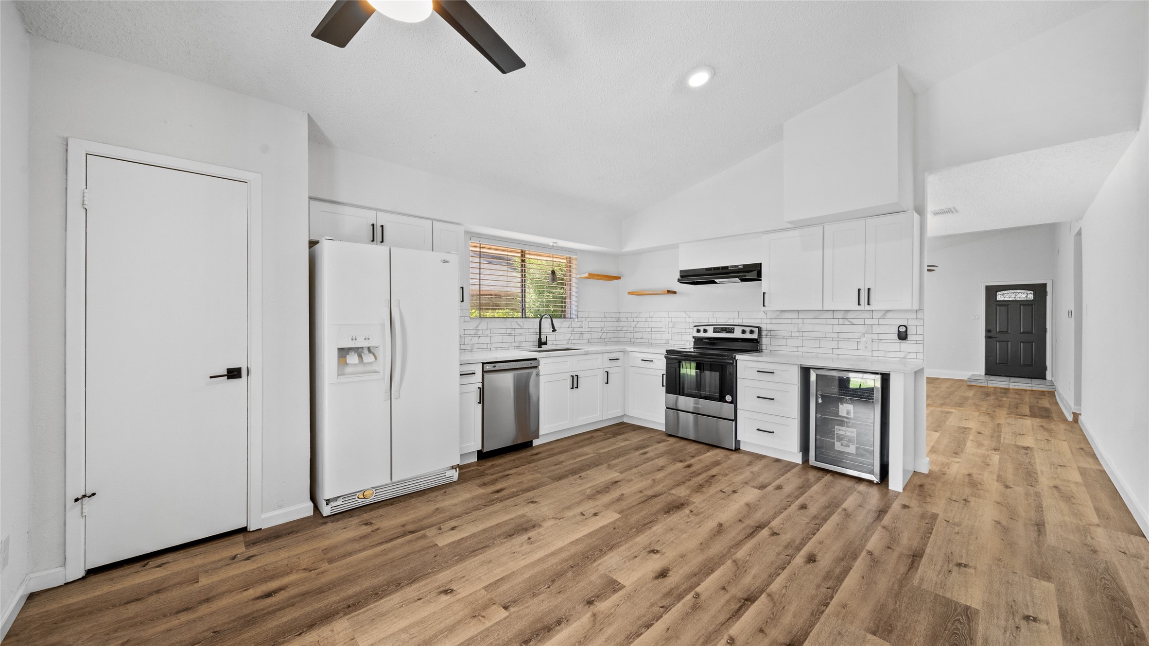 23414 Canyon Lake Drive Spring, TX 77373 - Photo 4 of 21 a kitchen with white cabinets and stainless steel appliances