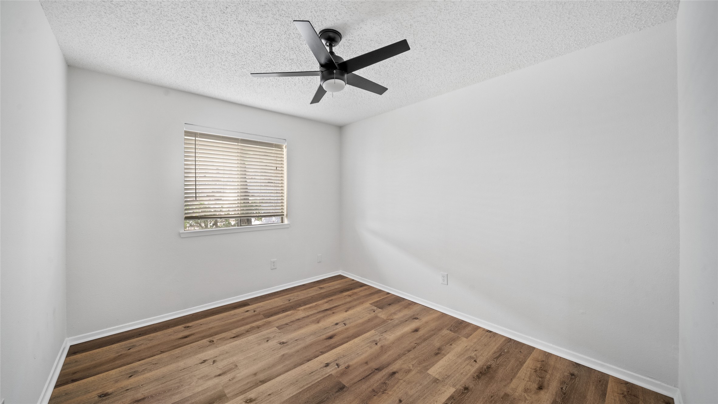 23414 Canyon Lake Drive Spring, TX 77373 - Photo 7 of 21 an empty room with wooden floor ceiling fan and windows