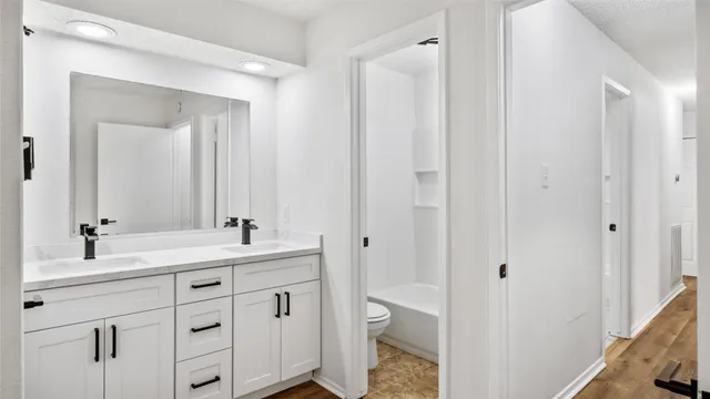 a bathroom with a double vanity sink and mirror