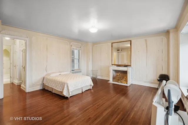 a spacious bedroom with a bed and a window