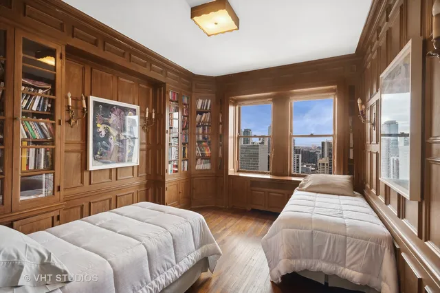 a bedroom with a bed and a large window with balcony view