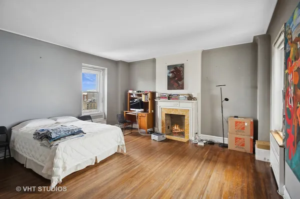 a spacious bedroom with a bed and a fireplace