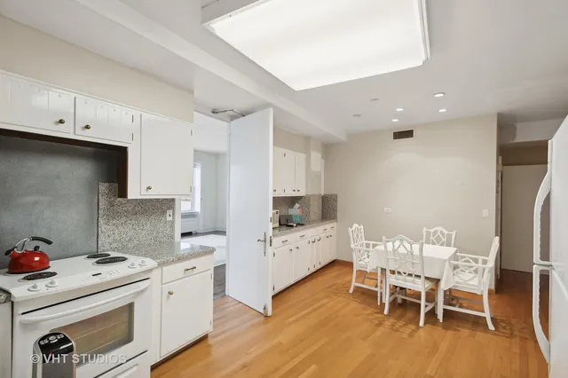 a kitchen that has a table and chairs in it