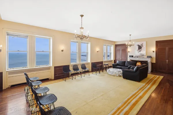 a living room with furniture and a chandelier