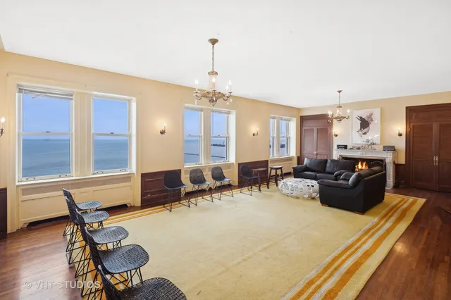 a living room with furniture and a chandelier