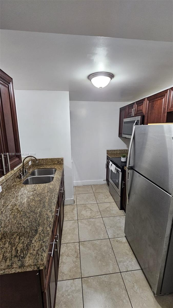 535 Northwest 19th Street, Unit 369 Miami, FL 33136 - Photo 20 of 26 a view of kitchen with stainless steel appliances granite countertop sink and stove
