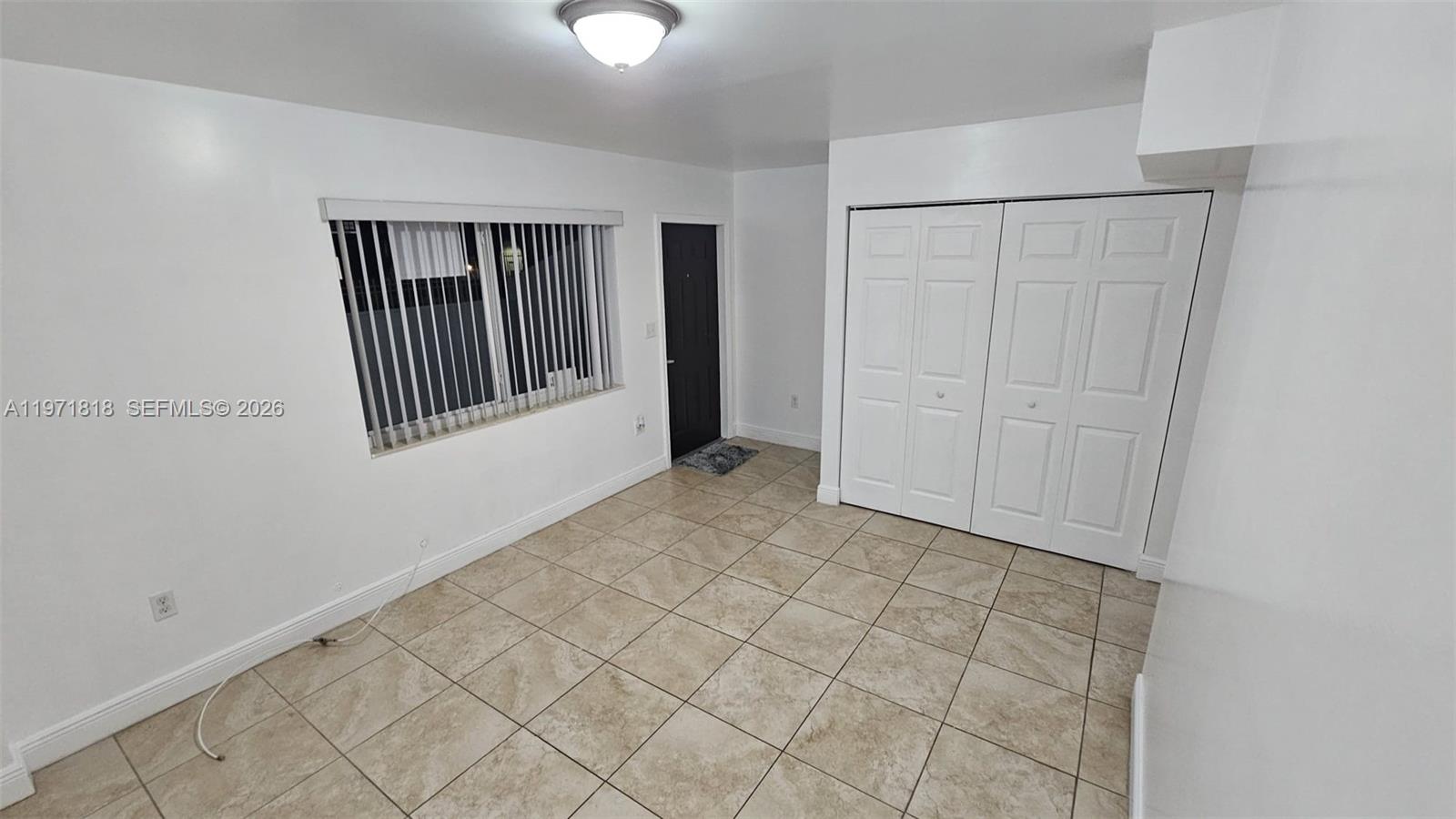 535 Northwest 19th Street, Unit 369 Miami, FL 33136 - Photo 6 of 26 an empty room with windows
