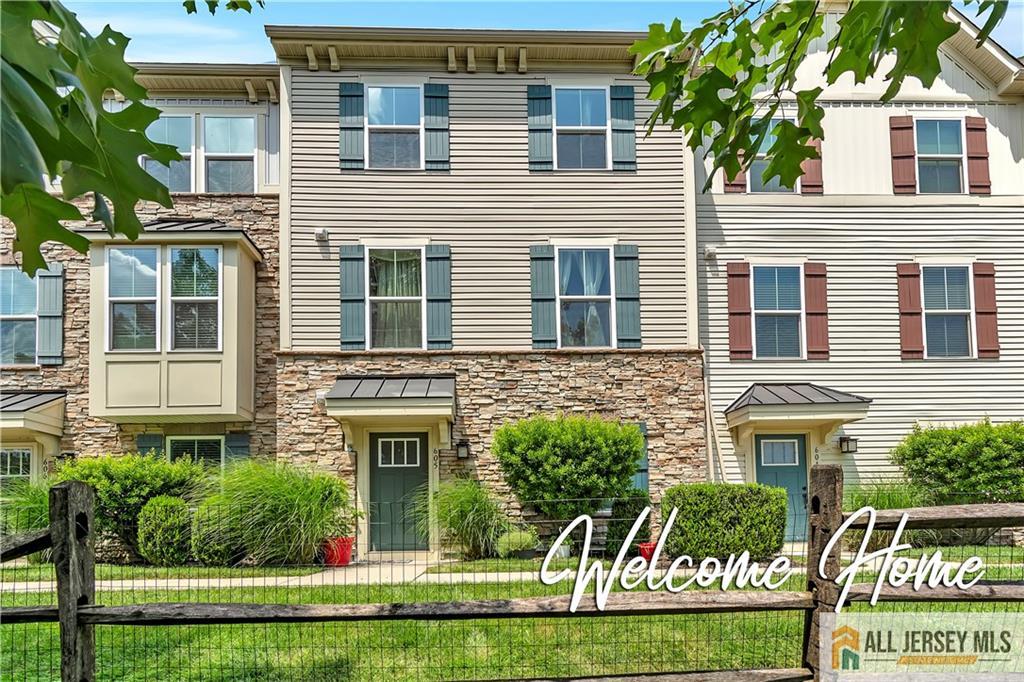 a front view of a residential apartment building with a yard