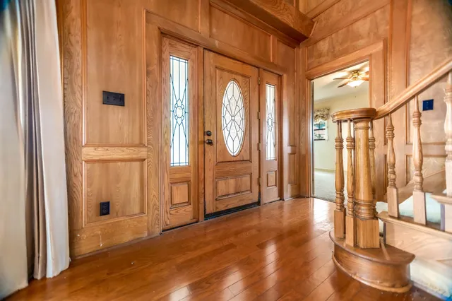 a view of an entryway with wooden floor and door