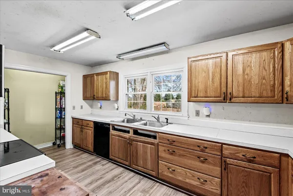 a view of living room kitchen with stainless steel appliances granite countertop furniture and fireplace