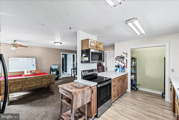 a kitchen with stainless steel appliances granite countertop a refrigerator and a stove top oven