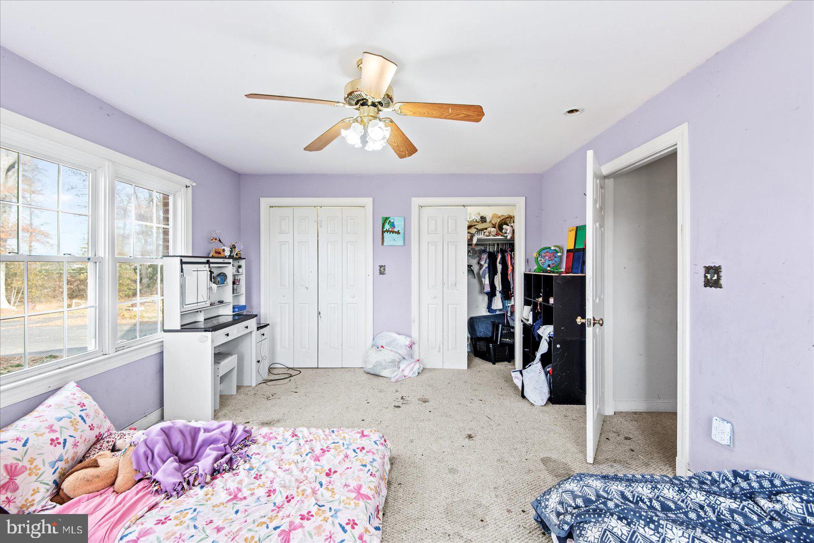 1606 Prospect Hill Road Montross, VA 22520 - Photo 24 of 32 a bedroom with a bed and a chandelier