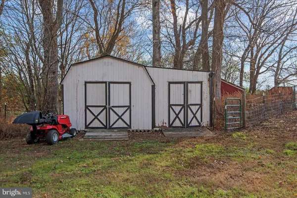 a view of a yard with wooden fence
