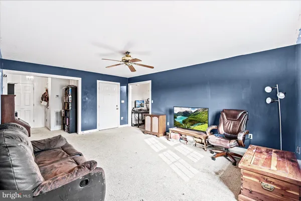 a living room with furniture and a chair