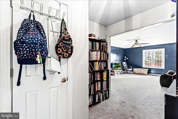 a living room with furniture a chandelier and a flat screen tv