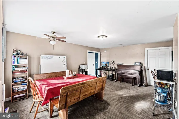 a kitchen with a table chairs stove and refrigerator