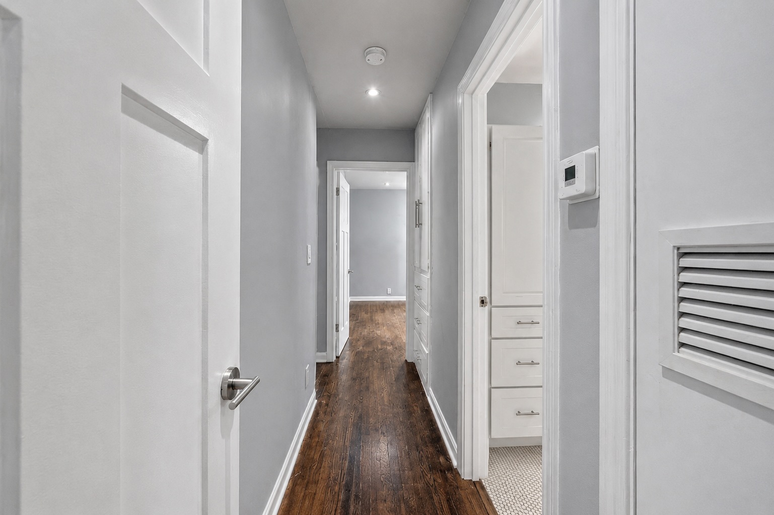 2105 Fortview Road Austin, TX 78704 - Photo 26 of 37 A refined corridor showcasing sleek wood flooring and subtle recessed lighting.