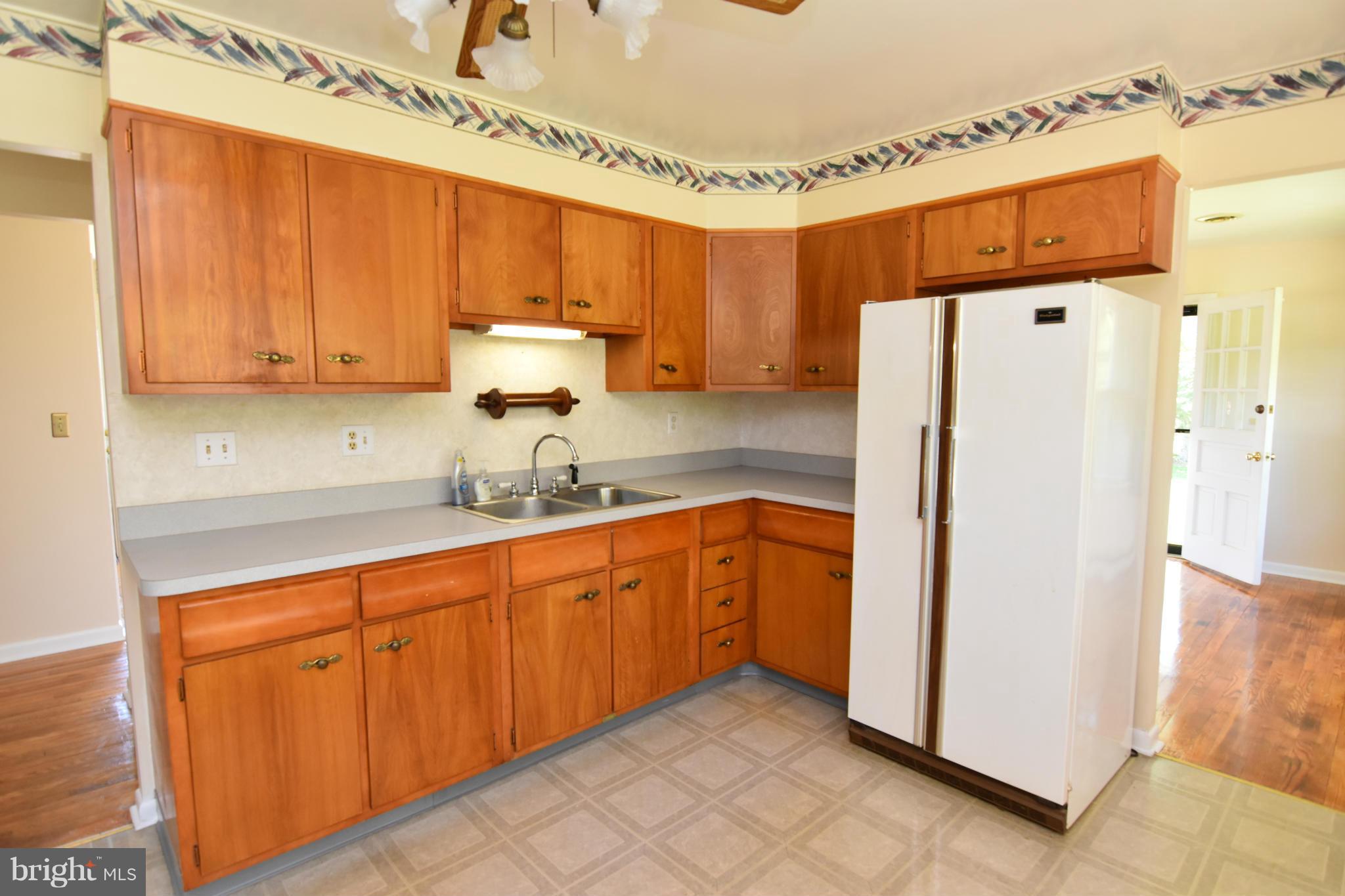 48632 Wynne Road Ridge, MD 20680 - Photo 8 of 30 a kitchen with stainless steel appliances granite countertop a refrigerator and a sink