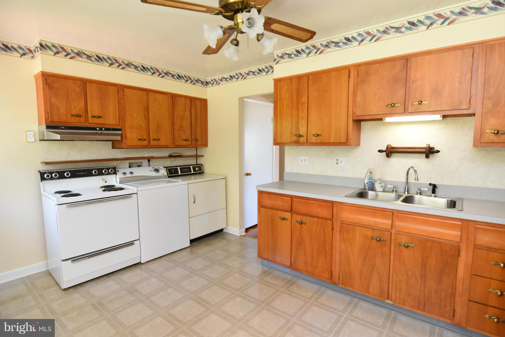 48632 Wynne Road Ridge, MD 20680 - Photo 9 of 30 a kitchen with stainless steel appliances granite countertop a stove sink and cabinets