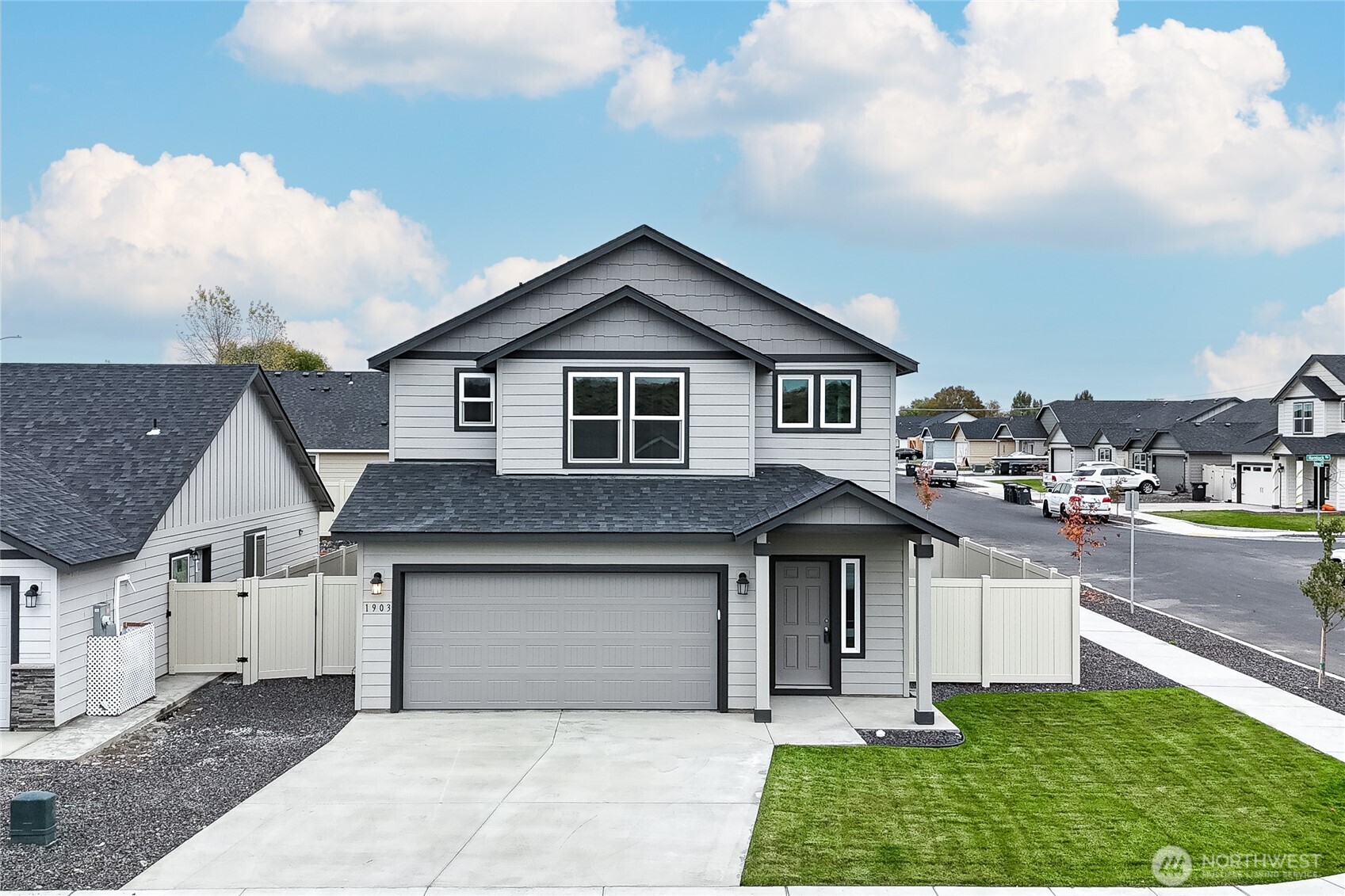 1903 Hickory Road Moses Lake, WA 98837 - Photo 1 of 12 a front view of a house with a yard and garage