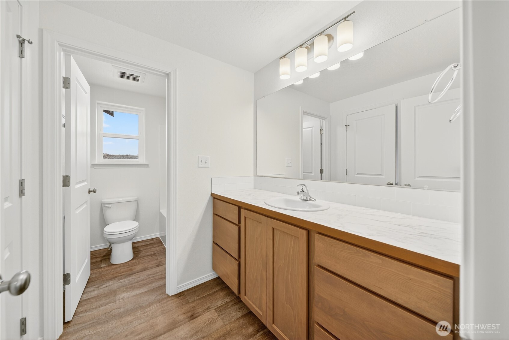 1903 Hickory Road Moses Lake, WA 98837 - Photo 9 of 12 a bathroom with a double vanity sink and a mirror