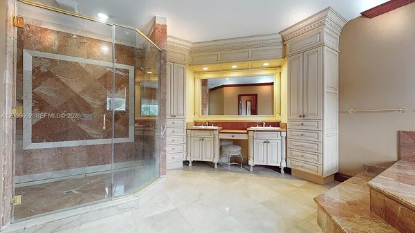 a bedroom with two beds and a chandelier