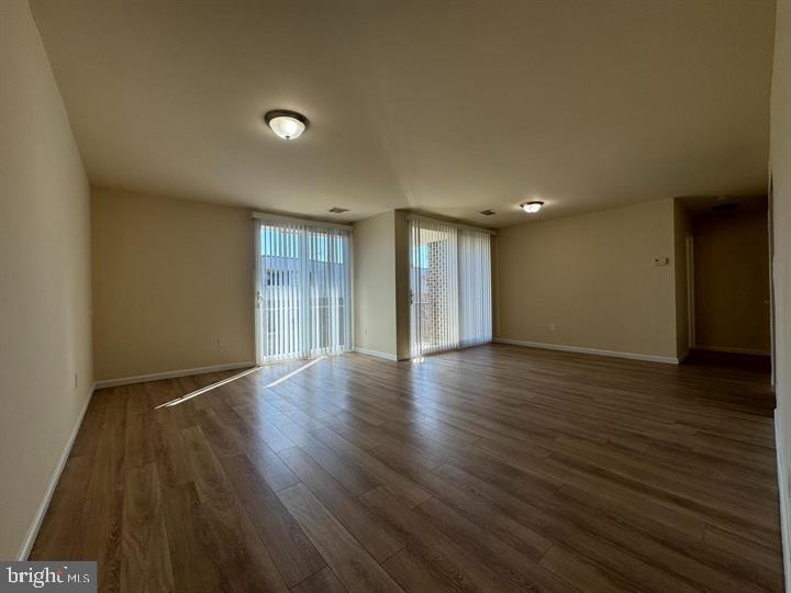10206 Prince Place, Unit 4203 Upper Marlboro, MD 20774 - Photo 1 of 10 a view of an empty room with wooden floor and closet