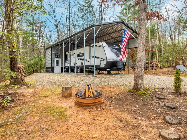a backyard of a house with barbeque oven table and chairs