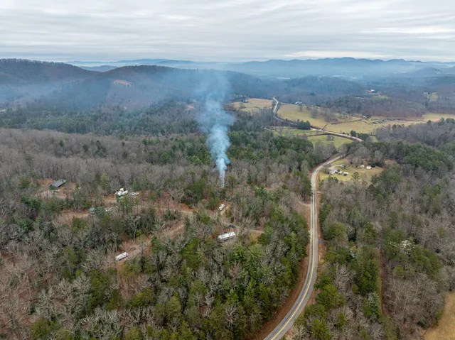 an aerial view of residential house and car parked
