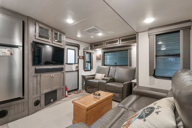 a living room with furniture a large window and a table