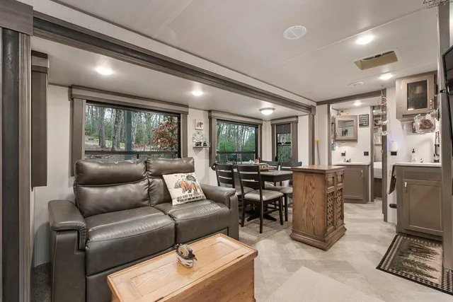 a kitchen with stainless steel appliances kitchen island granite countertop a stove and a microwave