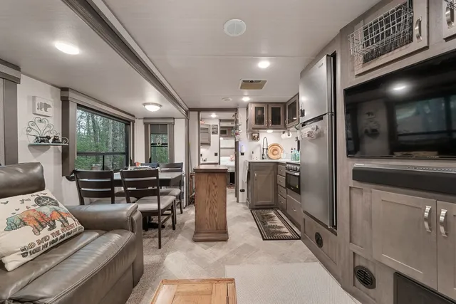 a kitchen with stainless steel appliances granite countertop a refrigerator and a stove
