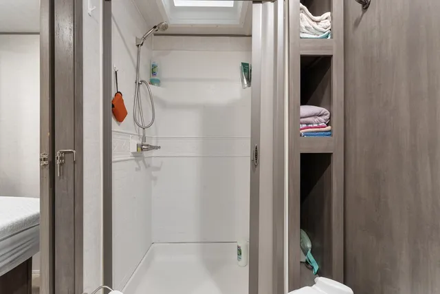 a spacious bathroom with a toilet a sink and a mirror