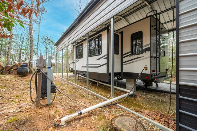 a view of a house with backyard and sitting area