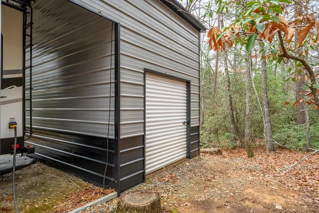 a view of a house with a yard and large tree and wooden fence