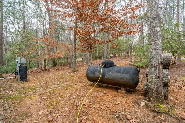 a view of a backyard with furniture and a fire pit