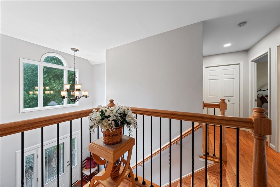 4568 Greenfield Road Bethlehem, PA 18017 - Photo 22 of 59 A striking arched window and elegant chandelier illuminate this grand entryway and staircase.