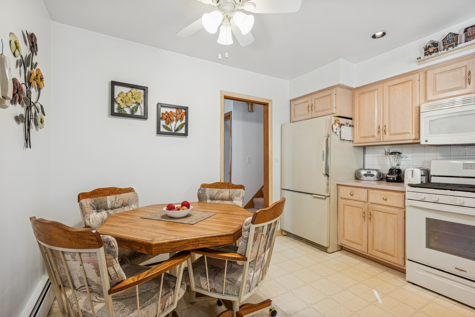 1725 Sycamore Street Des Plaines, IL 60018 - Photo 5 of 21 a kitchen with stainless steel appliances granite countertop a dining table chairs and a refrigerator