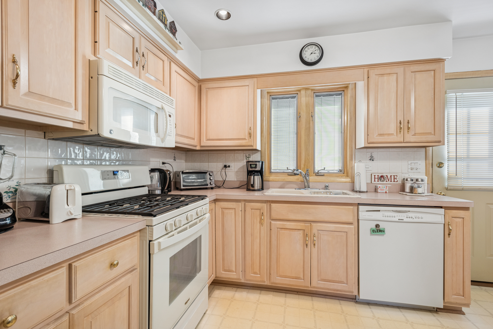 1725 Sycamore Street Des Plaines, IL 60018 - Photo 6 of 21 a kitchen with cabinets appliances a sink and a window
