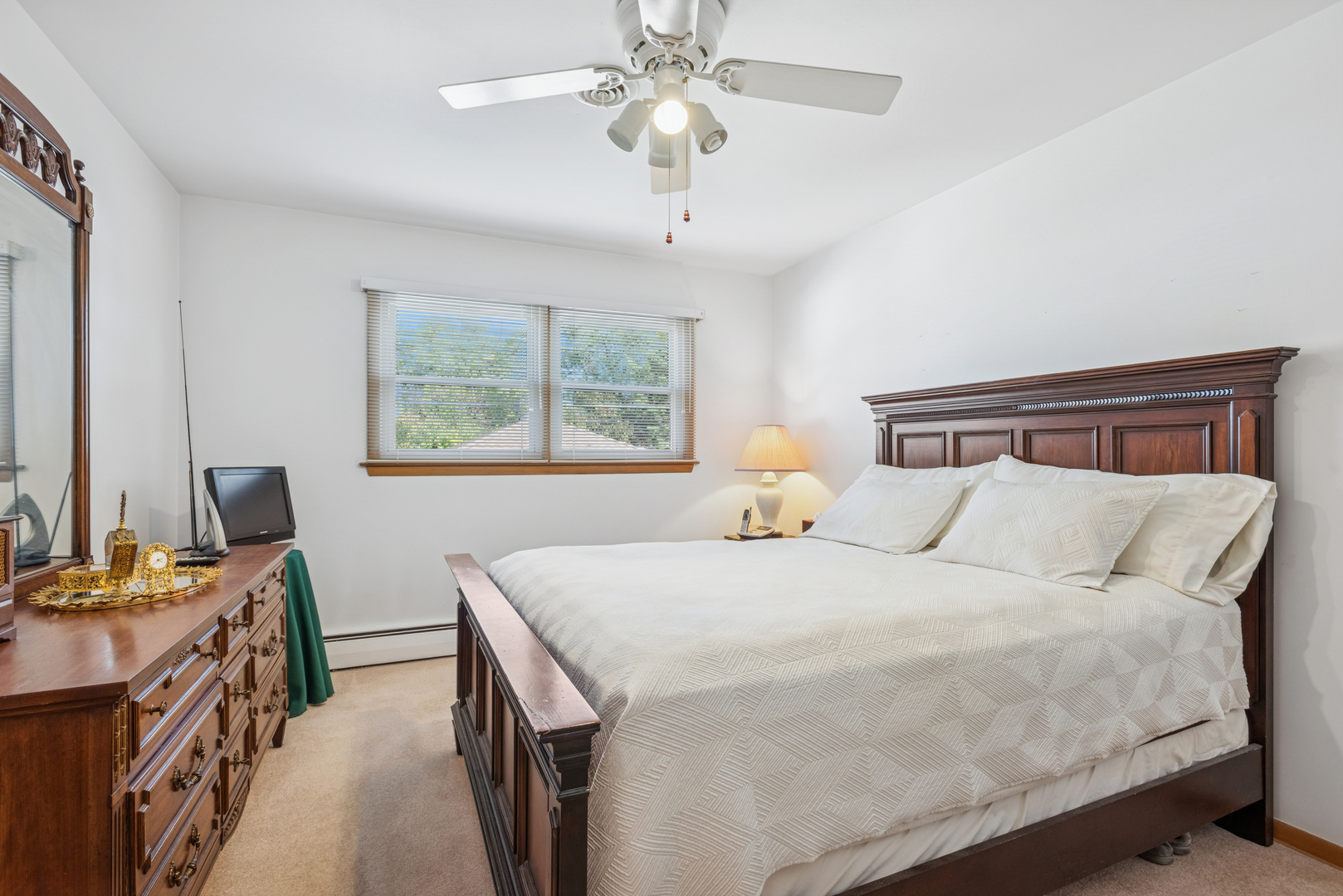 1725 Sycamore Street Des Plaines, IL 60018 - Photo 7 of 21 a bedroom with a bed and a chandelier