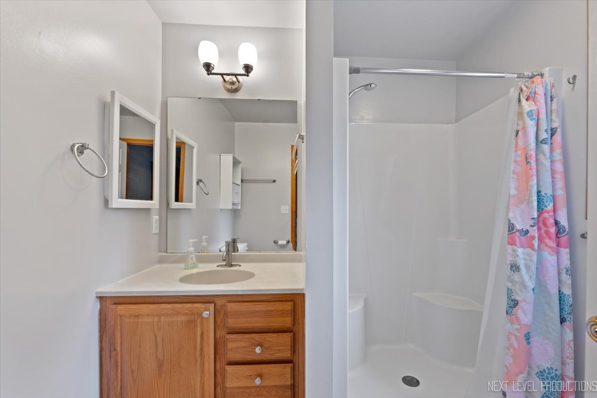 1146 Quail Run DeKalb, IL 60115 - Photo 17 of 31 a bathroom with a sink vanity tub and shower