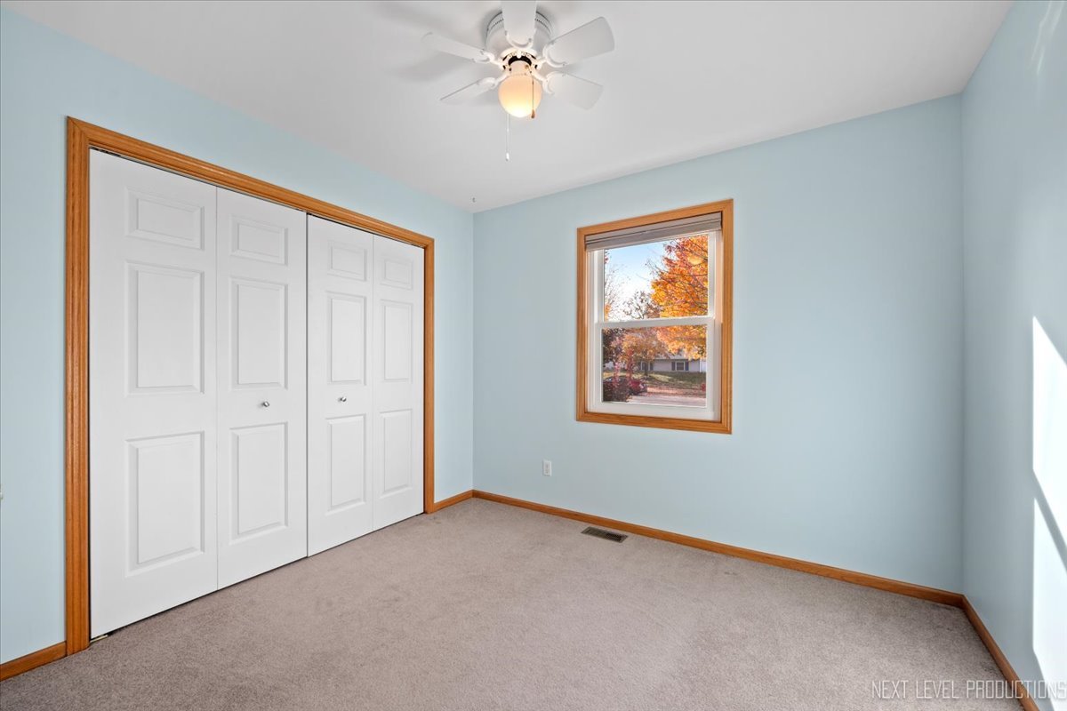 1146 Quail Run DeKalb, IL 60115 - Photo 19 of 31 wooden floor in an empty room with a window