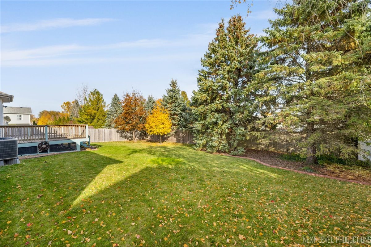 1146 Quail Run DeKalb, IL 60115 - Photo 24 of 31 a view of yard with swimming pool and trees in the background