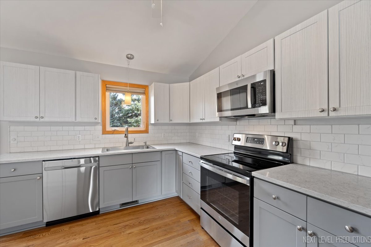1146 Quail Run DeKalb, IL 60115 - Photo 6 of 31 a kitchen with sink cabinets and stainless steel appliances