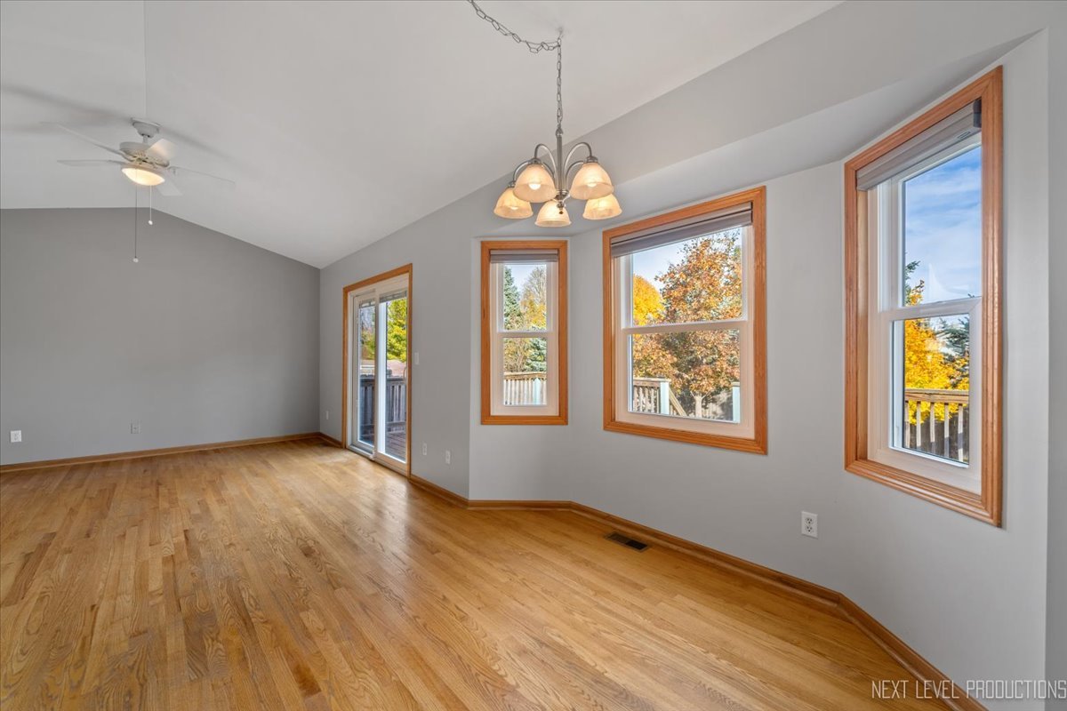 1146 Quail Run DeKalb, IL 60115 - Photo 9 of 31 a view of an empty room with wooden floor and a window