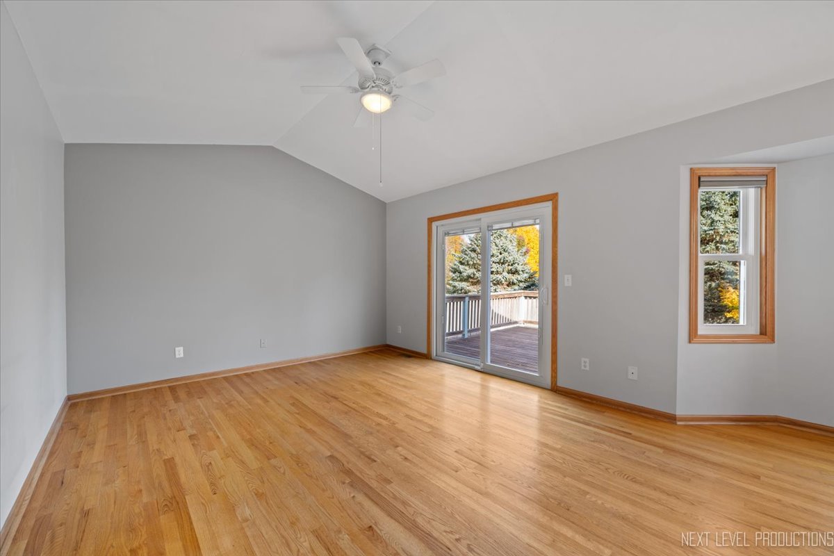 1146 Quail Run DeKalb, IL 60115 - Photo 10 of 31 a view of an empty room with wooden floor and a window