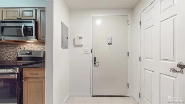 a kitchen with granite countertop a refrigerator and a sink