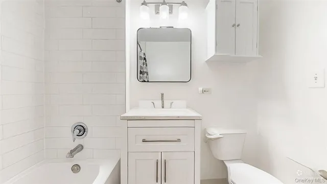 a bathroom with a sink toilet and vanity